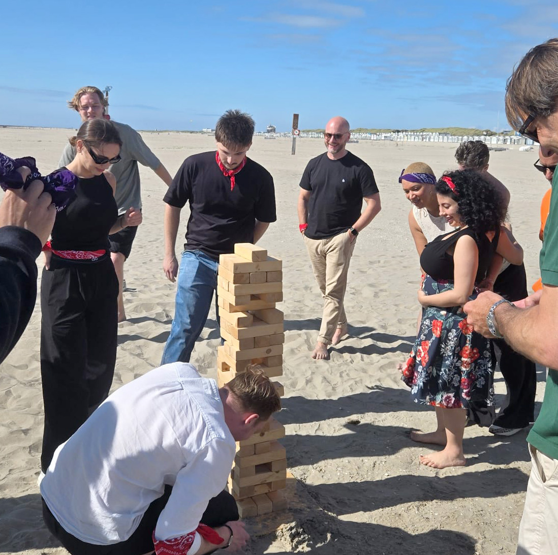 Levy Global playing beach jenga